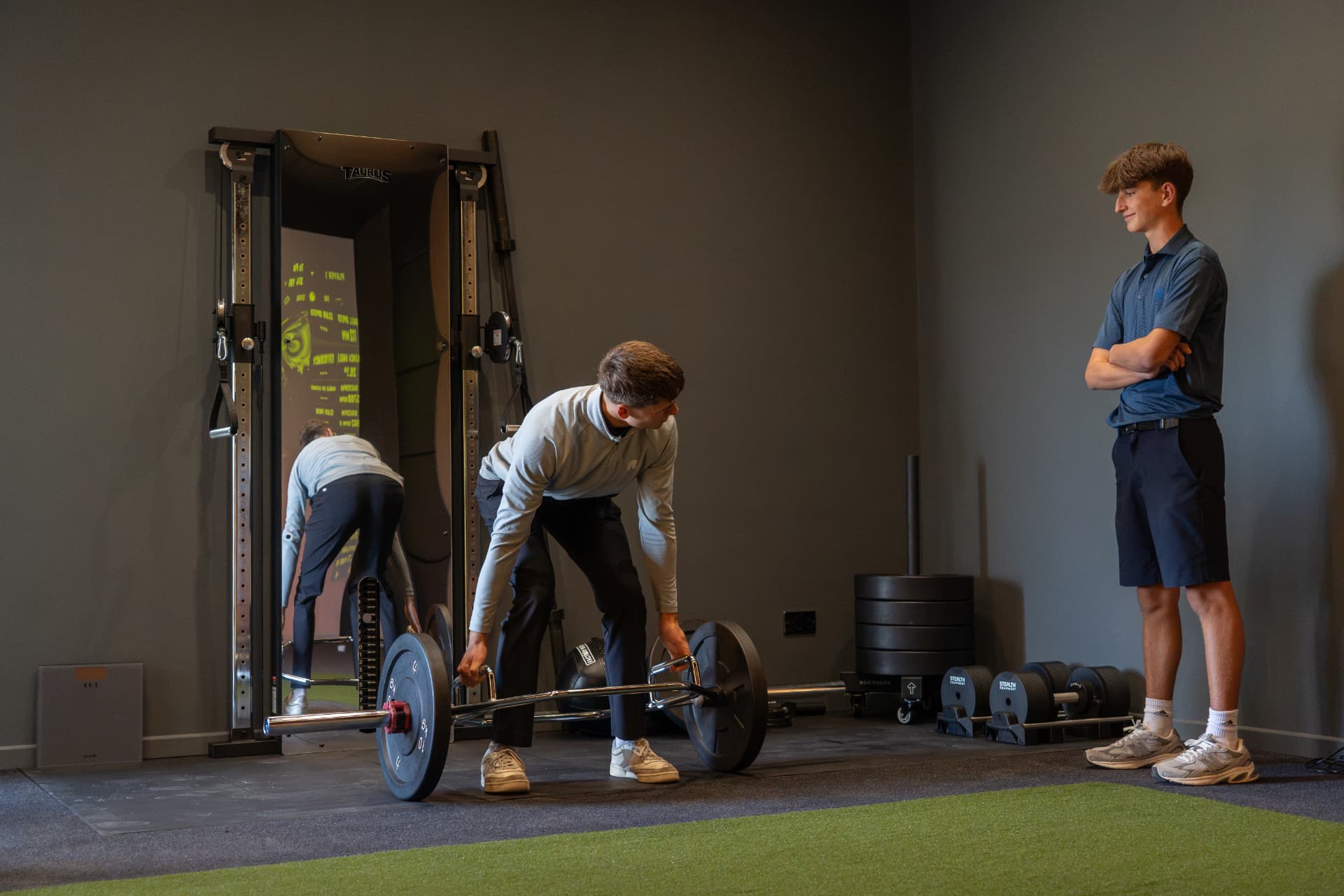 Coach supervising a trap bar lift in the COTT Coaching studio at Lewes Golf Club
